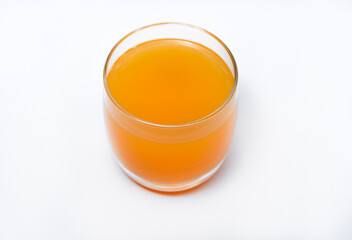 Glass glasses with orange juice on a white background. Delicious orange cooling drink.