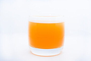 Glass glasses with orange juice on a white background. Delicious orange cooling drink.