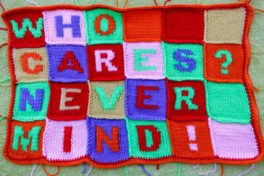 Hand knitted fabric with multi colored careless phrases