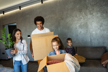 Mixed race family moving into their new home.