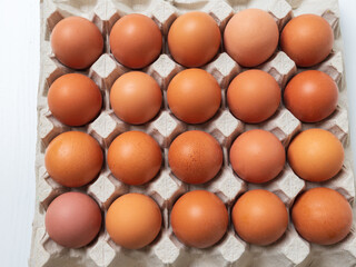Large chicken eggs are on a paper plate. Eggs for sale. Flatlay photo.