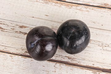 Two ripe sweet black plums
