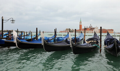 gondolas moored in the Venetian lagoon in Venice Italy