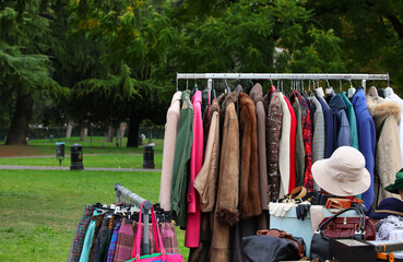 vintage used and new clothes for sale in the stall stand at the flea market