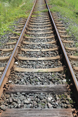 Fototapeta premium long iron train rail tracks to infinity with no people