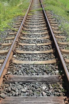 long iron train rail tracks to infinity with no people