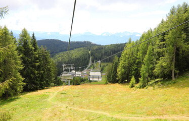 chairlift for the transport of hikers in the high mountains that crosses the forest