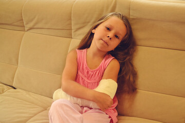 Cute little girl with a plaster cast on her arm