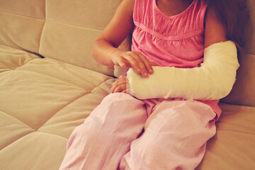 Cute little girl with a plaster cast on her arm