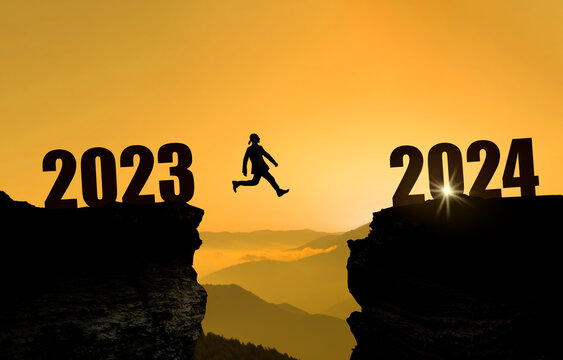 The anniversary begins. Welcome happy new year 2024. 
Businessman jumping on cliff 2024 over the precipice at sunset. New goals, success and business plans in business life