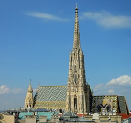 Bell tower and roof of Cathedral of Saint Stephen in Vienna in Austria and the imperial coat of arms of the Habsburg dynasty