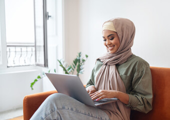 Happy Woman In Hijab Working Online On Laptop At Home