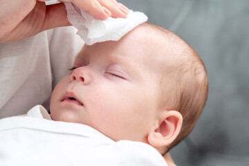 Wet wipe brings relief to newborn, Concept of maternal instinct during health concerns