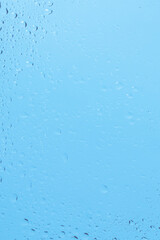 Blue backgrond with water drops. Wet glass.