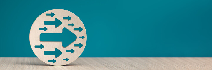 Arrow pointing right on a blue background. Banner with an arrow in a wooden circle close-up...
