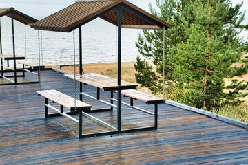 Relaxation area with tables by Lake Peipus. Lots of comfortable wooden sheds in a row with a view of the lake