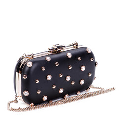Modern glamorous black long chain clutch bag for women, decorated with gold metal and pearl rivets...