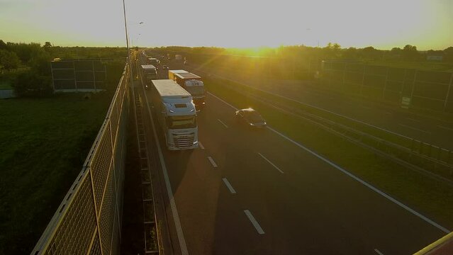 Cargo trucks with cargo trailer driving on a highway. Trucks deliver goods in early hours of the morning, A2 highway, Warsaw, Poland, September 2, 2023