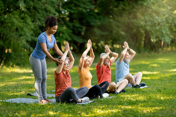 Outdoor Yoga Class. Group of smiling senior people training together outdoors