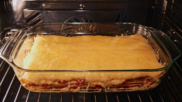 tasty cooking lasagna in the oven close-up time lapse