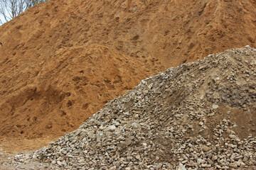 Fine grey gravel and yellow building sand for background or texture Construction materials Fillings Subsoil for paving.
