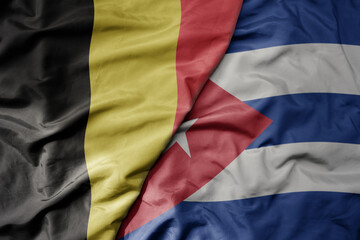 big waving national colorful flag of belgium and national flag of cuba .