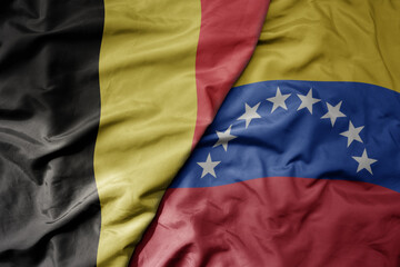 big waving national colorful flag of belgium and national flag of venezuela