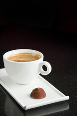 cup of americano with chocolate candy