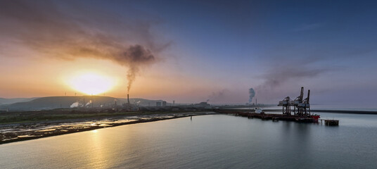 Editorial Port Talbot, UK - September 06, 2023: Sunrise and pollution over Port Talbot Steel Works, UK, also known as Tata Steel, Europe's second-biggest steelmaker.
