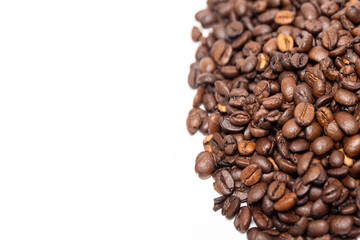 Coffee beans on a white table. Roasted coffee beans on a white background, top view, copy space.coffee beans on a white background