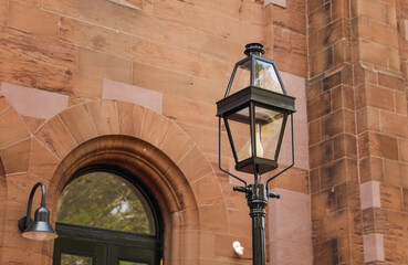 Fototapeta na wymiar street lamp, a beacon in the city's night, symbolizes both historic charm and modern urban allure, casting a warm glow on our urban journey