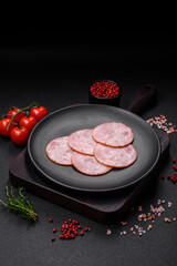 Delicious fresh ham cut into round slices with salt, spices and herbs