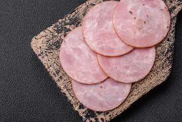Delicious fresh ham cut into round slices with salt, spices and herbs