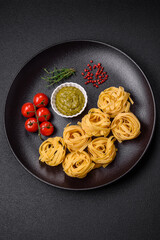 Delicious fresh pasta consisting pesto sauce with salt, spices and herbs