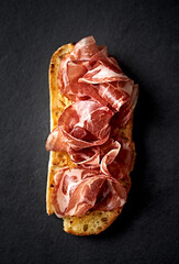 Italian Coppa Ham on bread toast. Top view. Close-up - 644612601