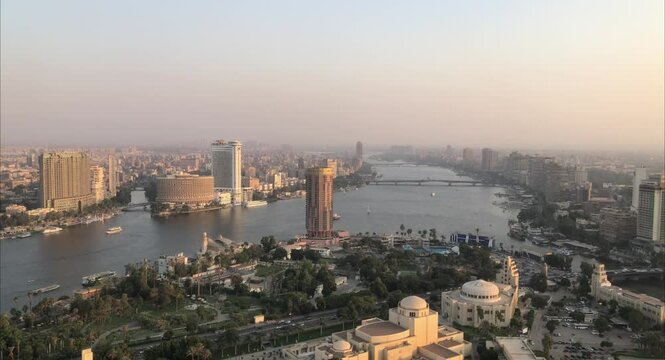 Cairo, Egyptpanoramic aerial sunset view of the Nile and downtown Cairo with traffic and boats seen from Cairo Tower - 29,Aug 2023.
