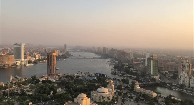 Cairo, Egyptpanoramic aerial sunset view of the Nile and downtown Cairo with traffic and boats seen from Cairo Tower - 29,Aug 2023.
