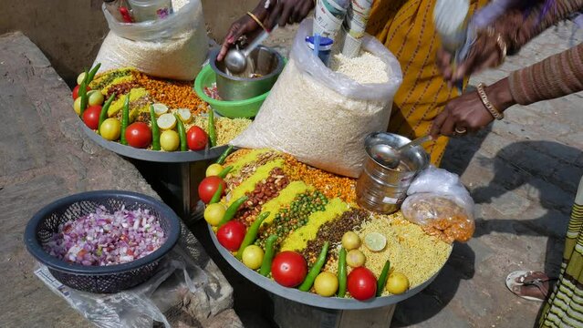 Street food vendors preparing spicy traditional Indian snack Chana Jor Garam or Chana Chor Garam at a street market in Jaipur, Rajasthan, India.