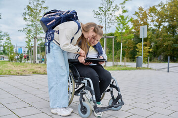 Obraz premium Children together outdoor, girl and boy on wheelchair talking near school building