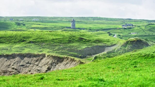 Grassy fields with castle tower. Ireland