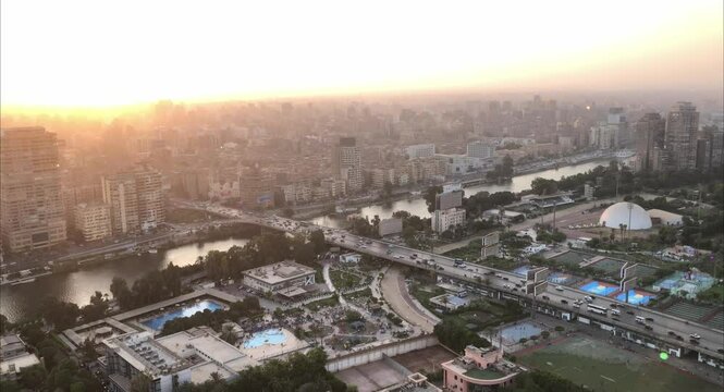 Cairo, Egyptpanoramic aerial sunset view of the Nile and downtown Cairo with traffic and boats seen from Cairo Tower  -  29,Aug 2023.