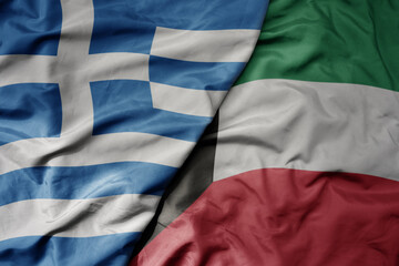 big waving national colorful flag of greece and national flag of kuwait .