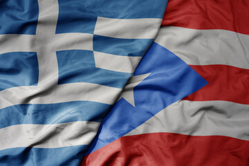big waving national colorful flag of greece and national flag of puerto rico .