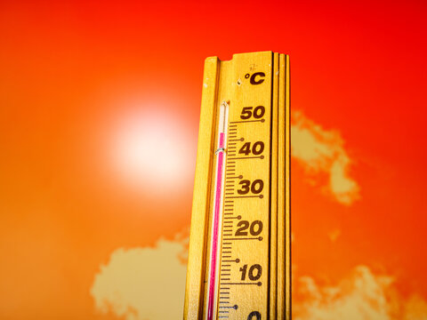 Hot summer day, the thermometer displays a high heatwave temperature of 47 degrees Celsius. Red alarm warning and Extreme weather conditions caused by global climate change on Earth.