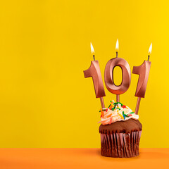 Number 101 birthday candle - Celebration on yellow background