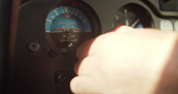 Man adjusting gauges and indicators in helicopter cockpit. Pilot performing preflight procedure. Airport and aviation concept