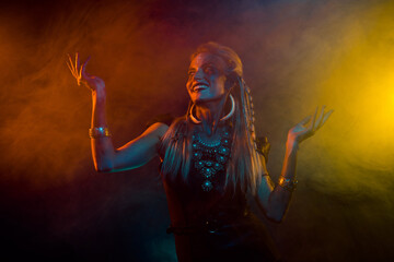 Photo of cool crazy woman wear gothic valkyrie costume dancing ritual music isolated orange fog...