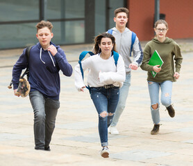 Group of running children with backpacks, they ready to go home from school