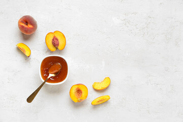 Composition with bowl of tasty peach jam and fresh fruits on light background