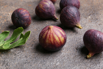 Fresh ripe figs and leaf on dark background
